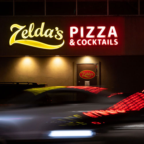 The front door is locked but side door is open for picking up food at Zelda’s Original Gourmet Pizza, known for their Chicago-style deep dish pizza for over 40 years, seen past 21st Street evening traffic Tuesday, Dec. 22, 2020, in midtown Sacramento.
